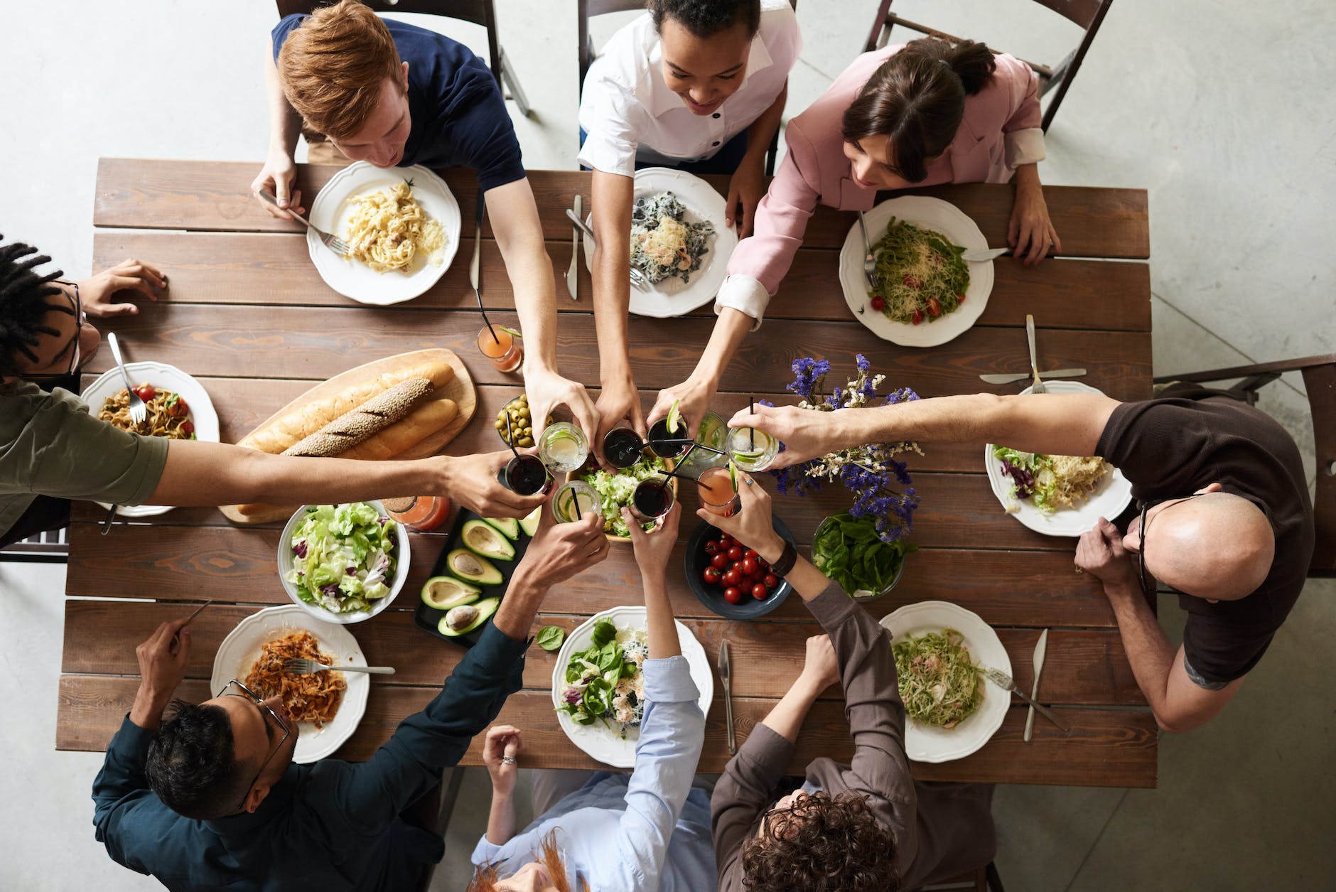 A group of friends at a table having lunch.